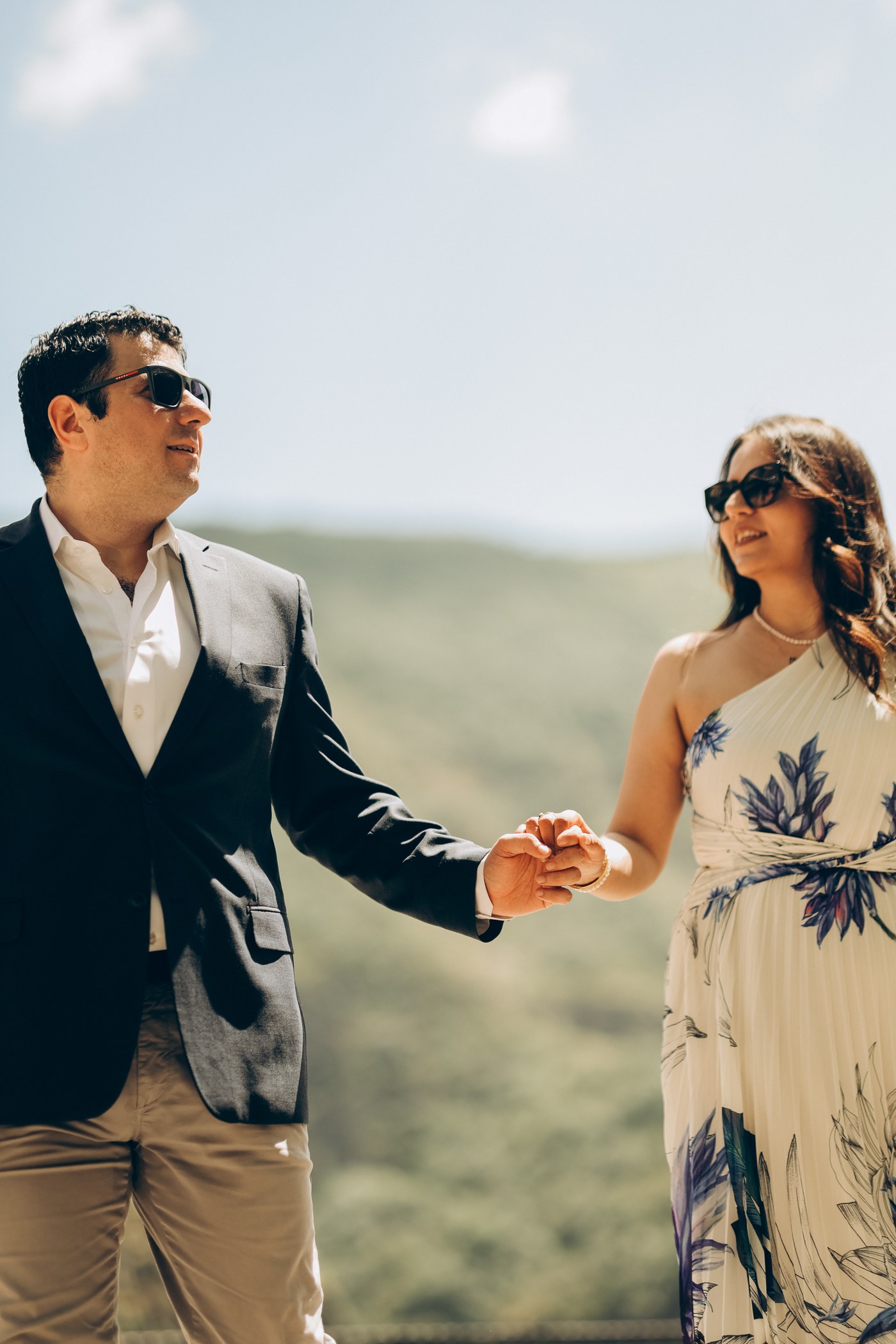 Haik and Astghik holding hands outdoors in the hills